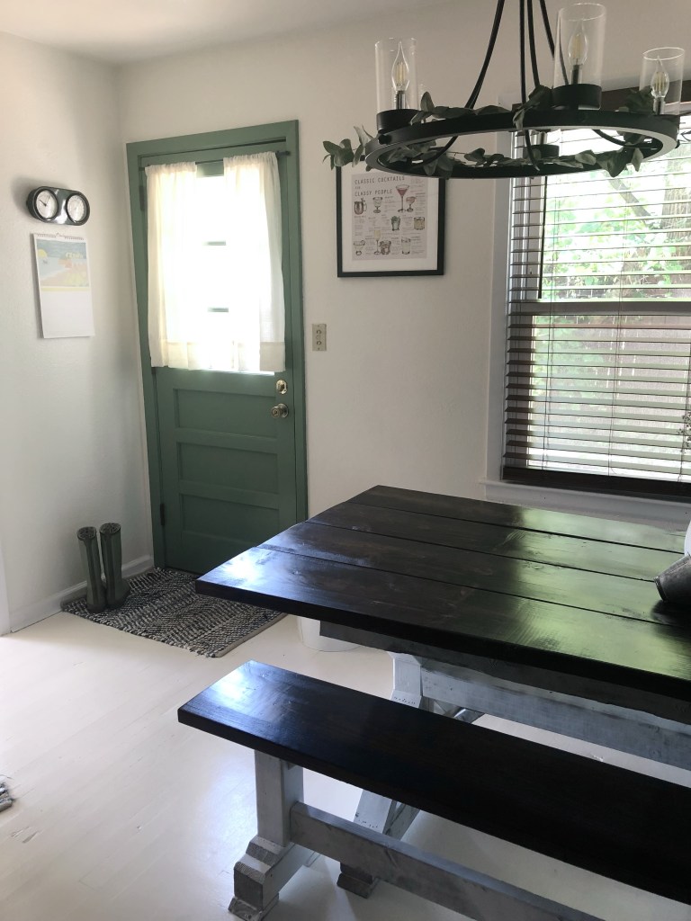 A side door has a cocktail recipe photo, national parks calendar, and wall clock in its nook.