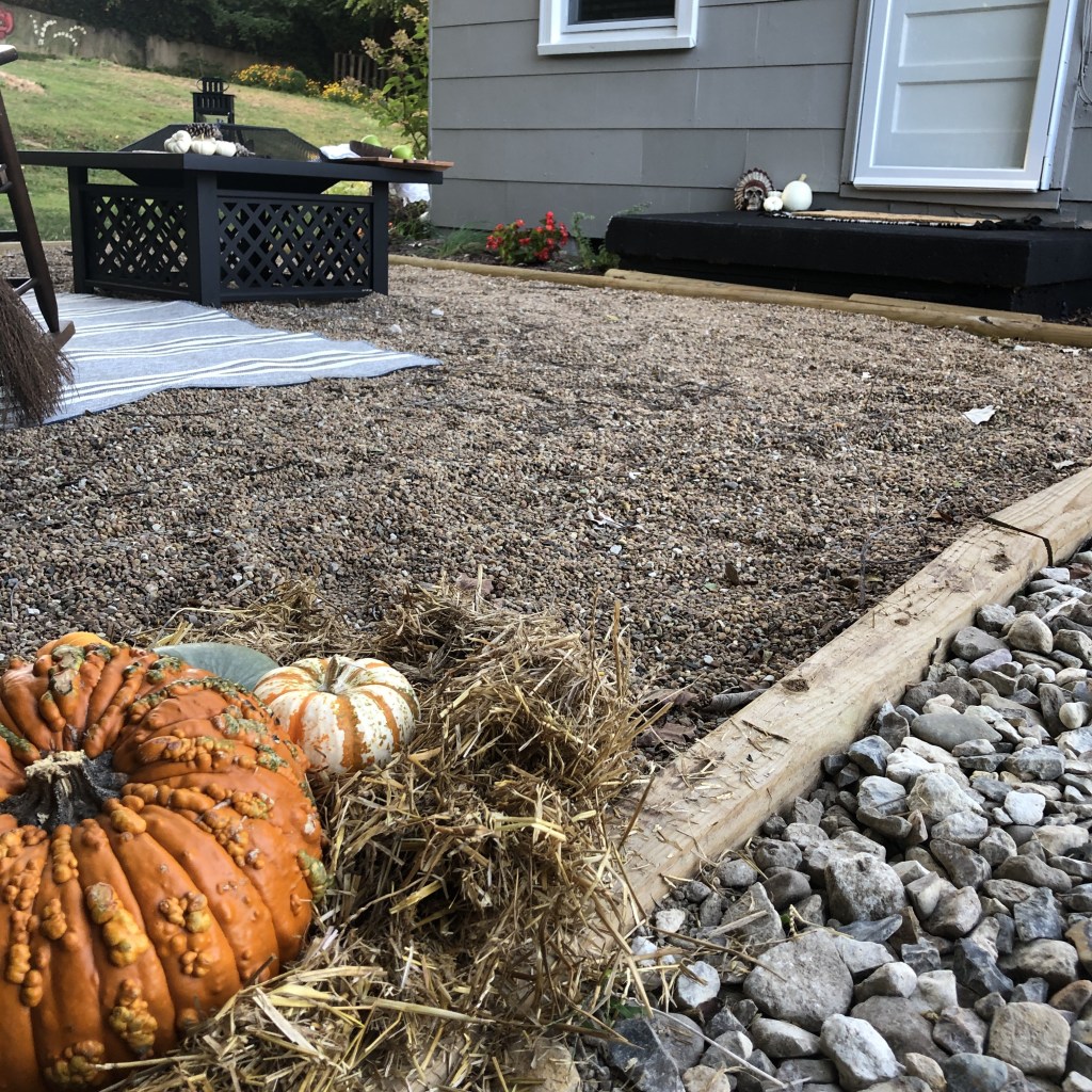 A low view of pumpkins sits in front of a newly decorated patio.
