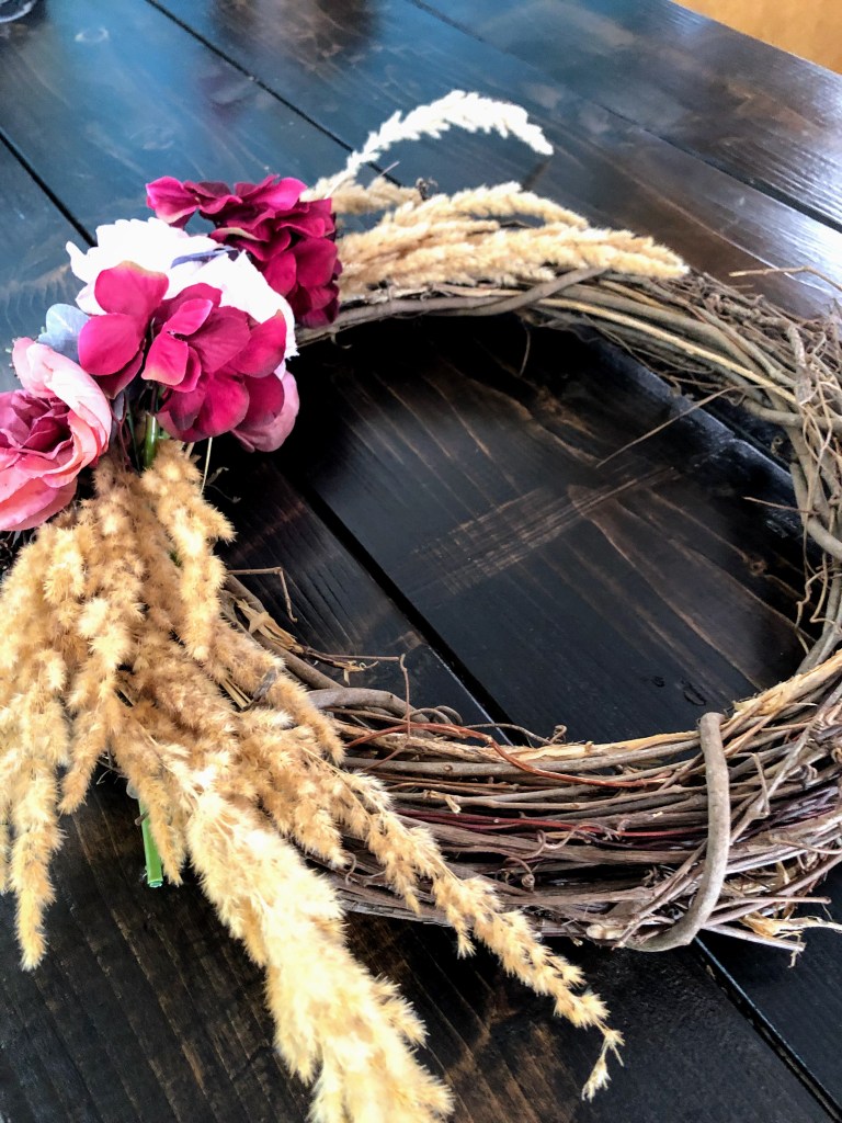 A perfect fall wreath, handmade on a table.