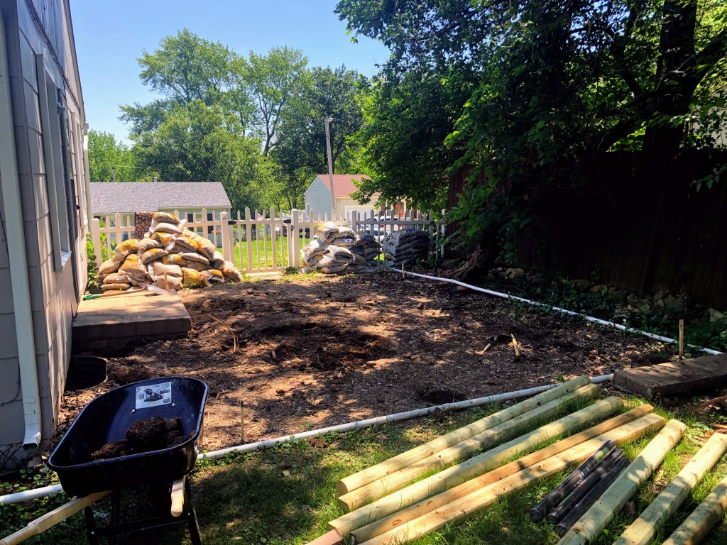 Stakes and line mark the area for a patio to be installed.