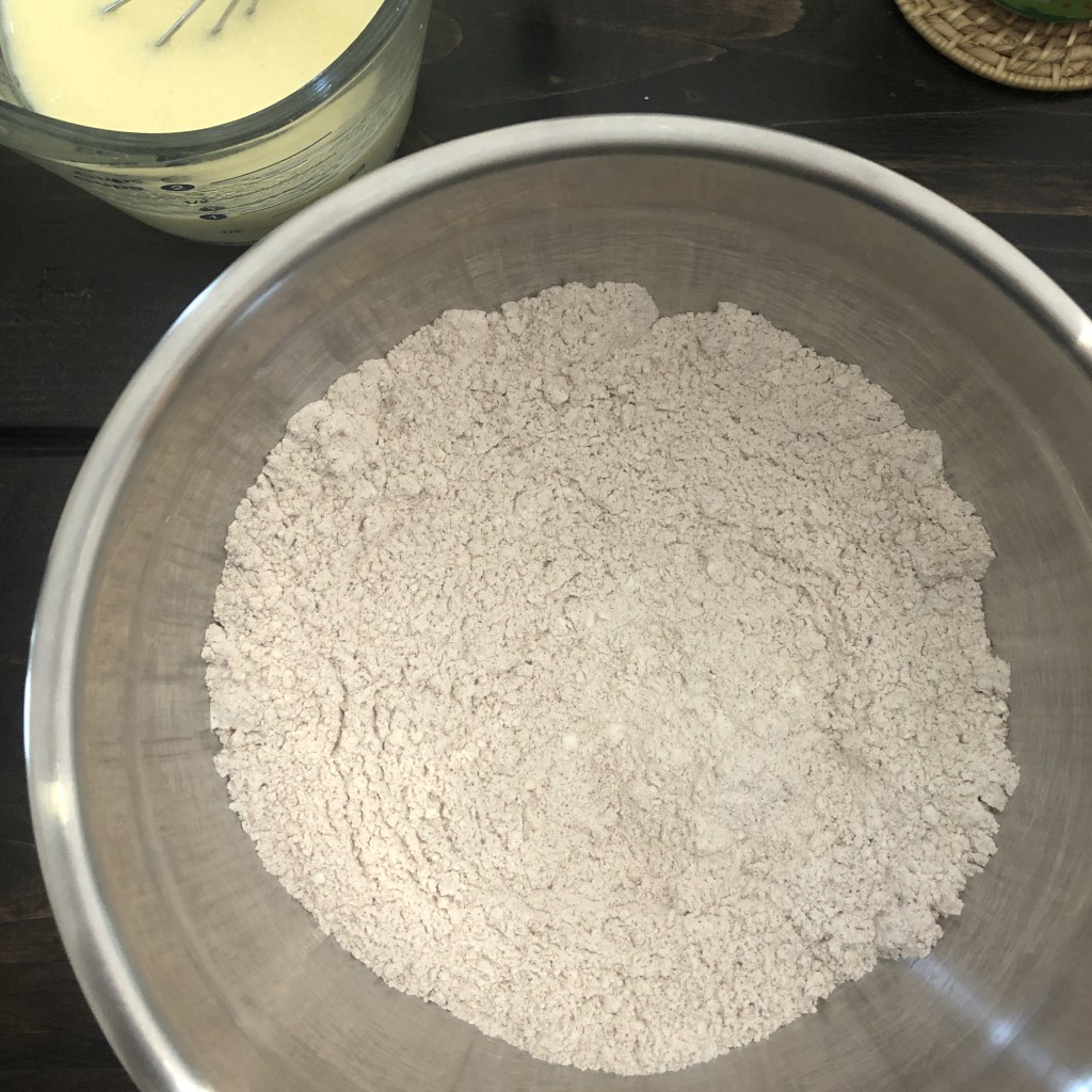 Dry ingredients sit in a bowl, just waiting to be mixed into this fall muffin recipe.