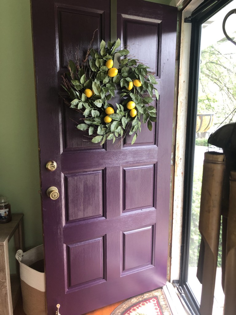 A finished plum painted door after it’s been stripped.