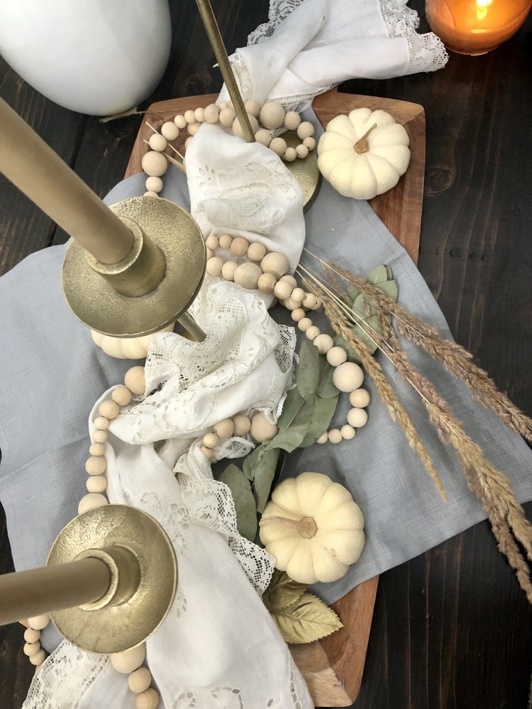 A bird’s eye view of a Thanksgiving centerpiece in a dining room.