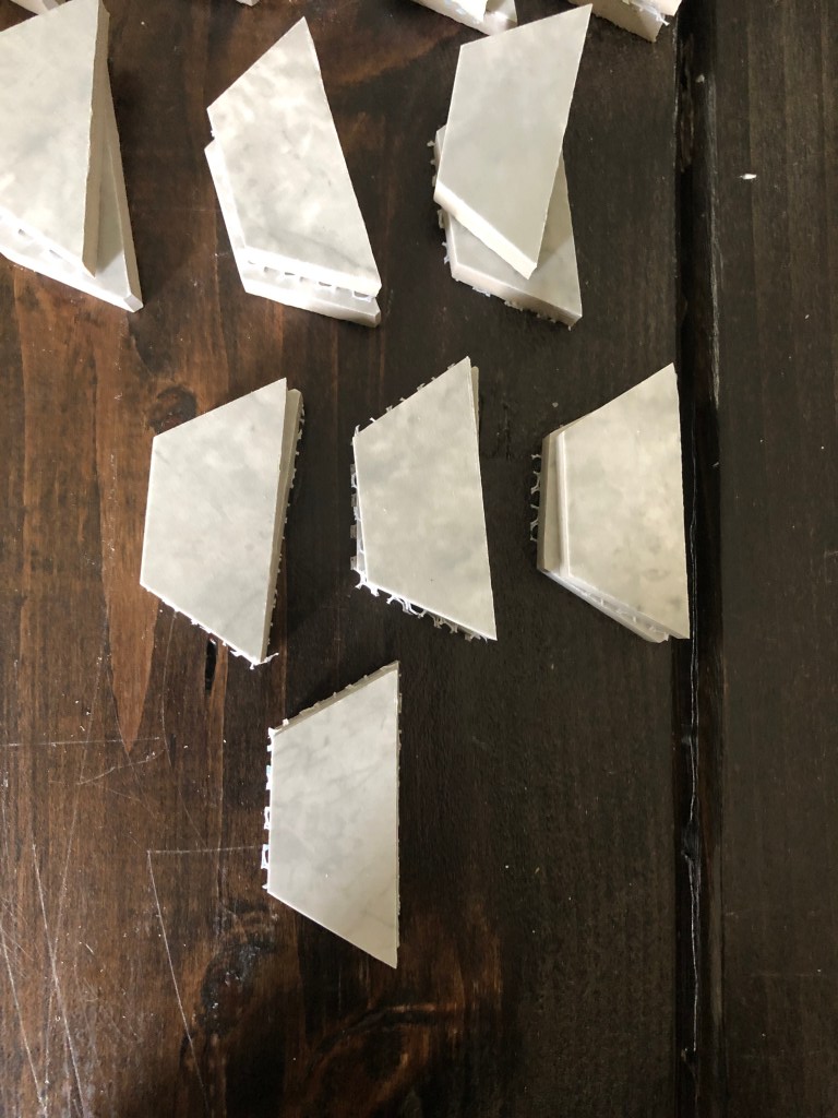 Hexagonal floor tile has been cut for edges in a bathroom.