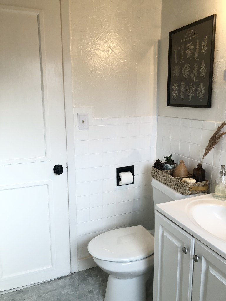 A newly restored bathroom has an updated, antique style look. 