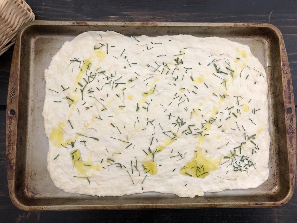 Flatbread has been pressed into a cookie sheet for baking.
