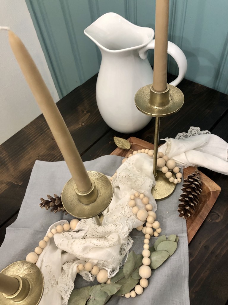 Natural elements and more are being used to create a beautiful centerpiece for a table display.