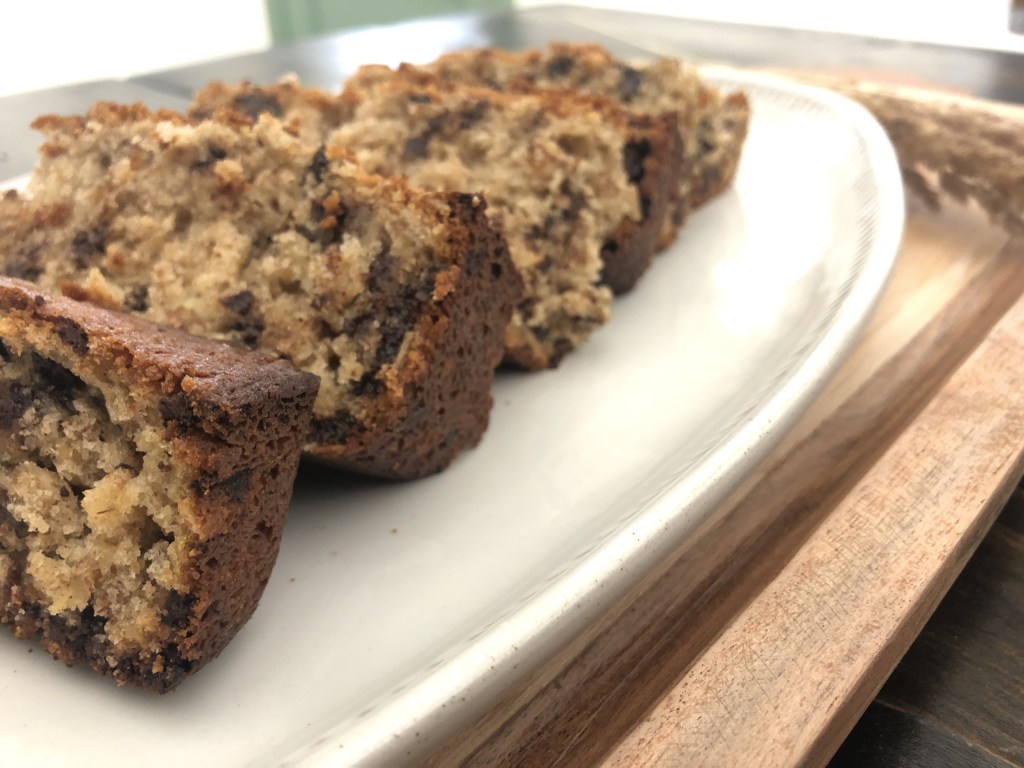 Chocolate Chip Banana Bread sits on a platter waiting to be served.