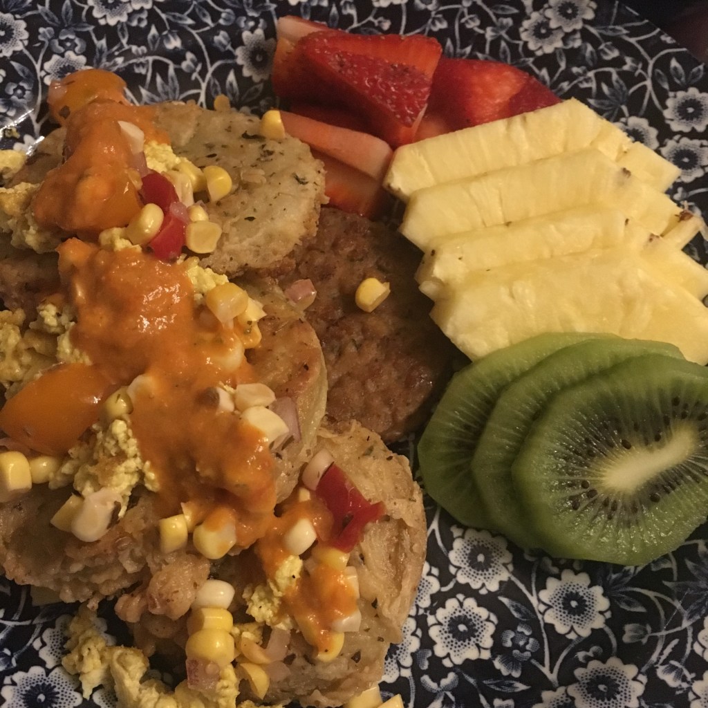 Fried green tomatoes and tofu scramble with vegan sausage and fresh fruit await guests.
