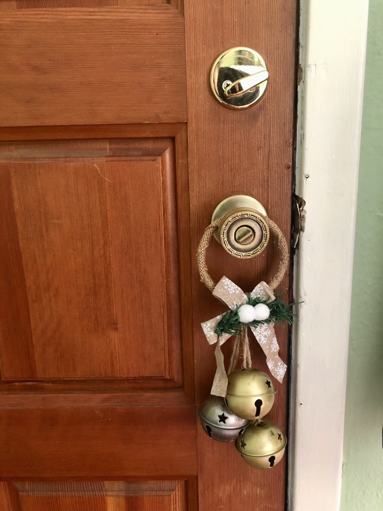 A bell has been placed on a door knob for winter.