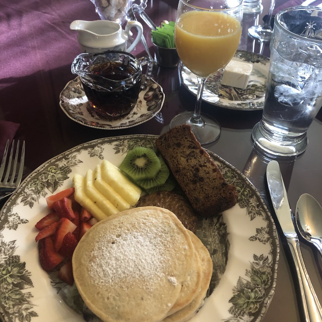 Pancakes, banana bread, fresh fruit, and vegan sausage await B&B guests in the morning.