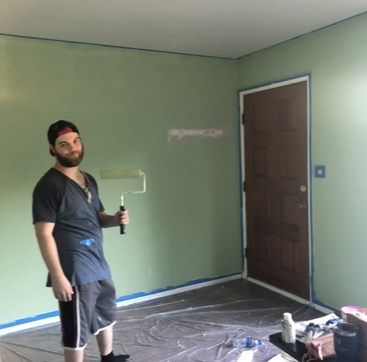 A DIY home renovation is complete by painting a living room a soft, light green.