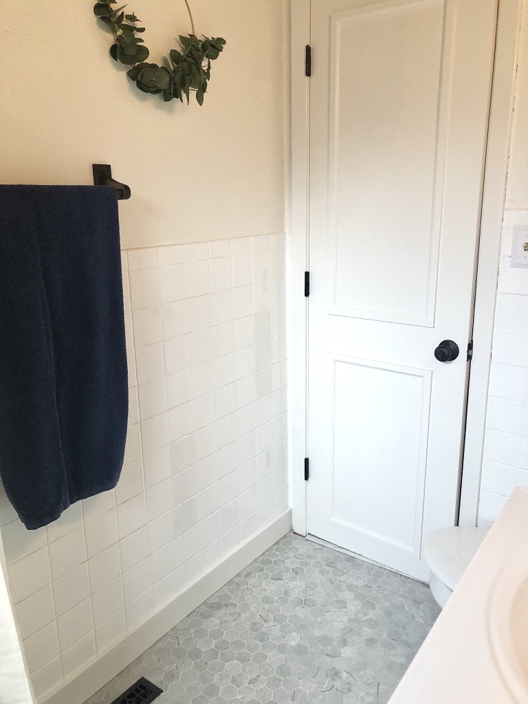 A DIY interior door makeover turns a door into a sleek white, old-fashioned door.