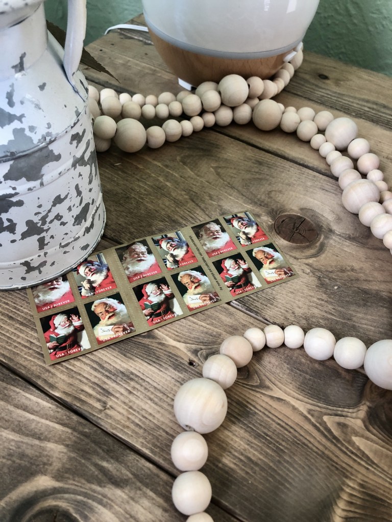 Wood beaded garland is draped around a vase for the holidays.