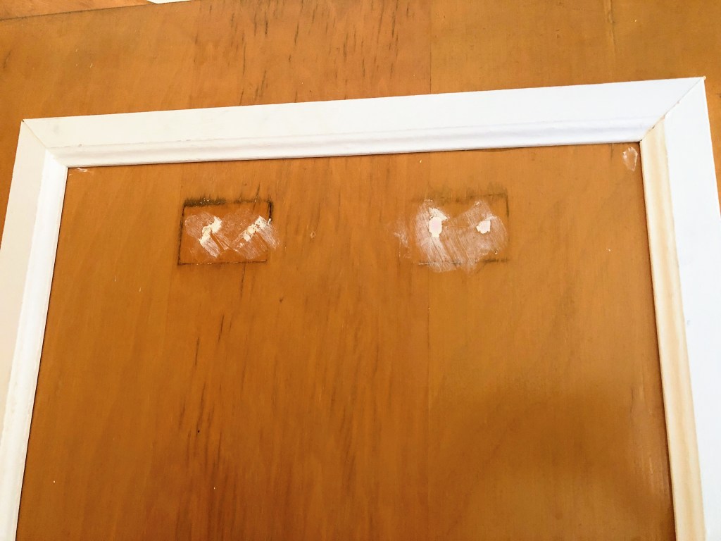 Spackle is drying on an old door.