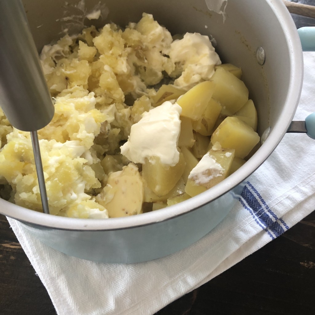 Mashed potatoes are incorporated with other ingredients for a feast.