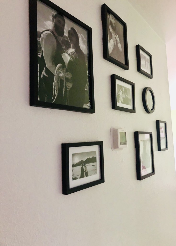 A gallery wall lines one side of a newly renovated hallway.