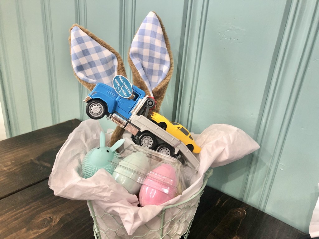 Easter basket ideas for toddlers are easy in this cute basket filled with pastel toys.
