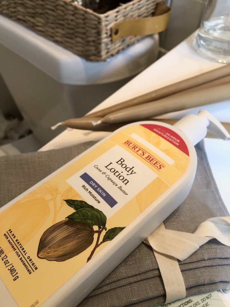 Burt's Bees body lotion, a favorite clean beauty product of mine, sits in a bathroom waiting to be slathered on.