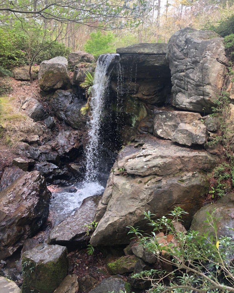 A waterfall flows into hot springs in the middle of Hot Springs, Arkansas in Hot Springs National Park.
