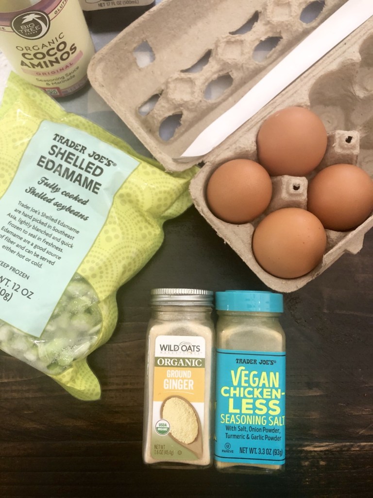 Farm fresh eggs, frozen edamame, ginger, and vegan chicken less seasoning sit on a tabletop.