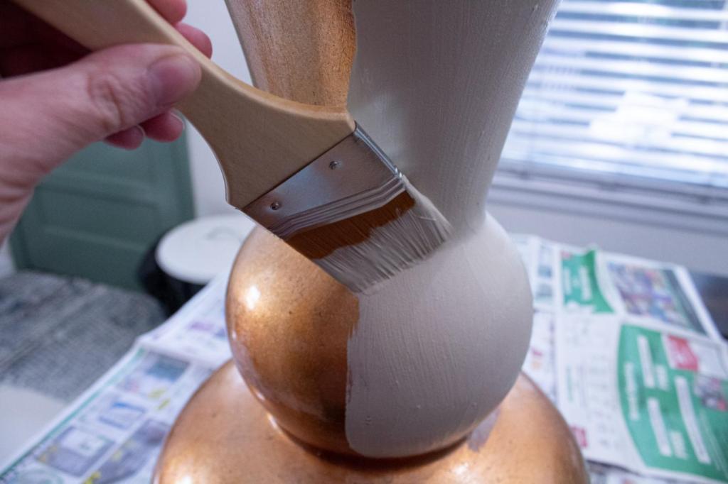 An old gaudy vase is being painted.