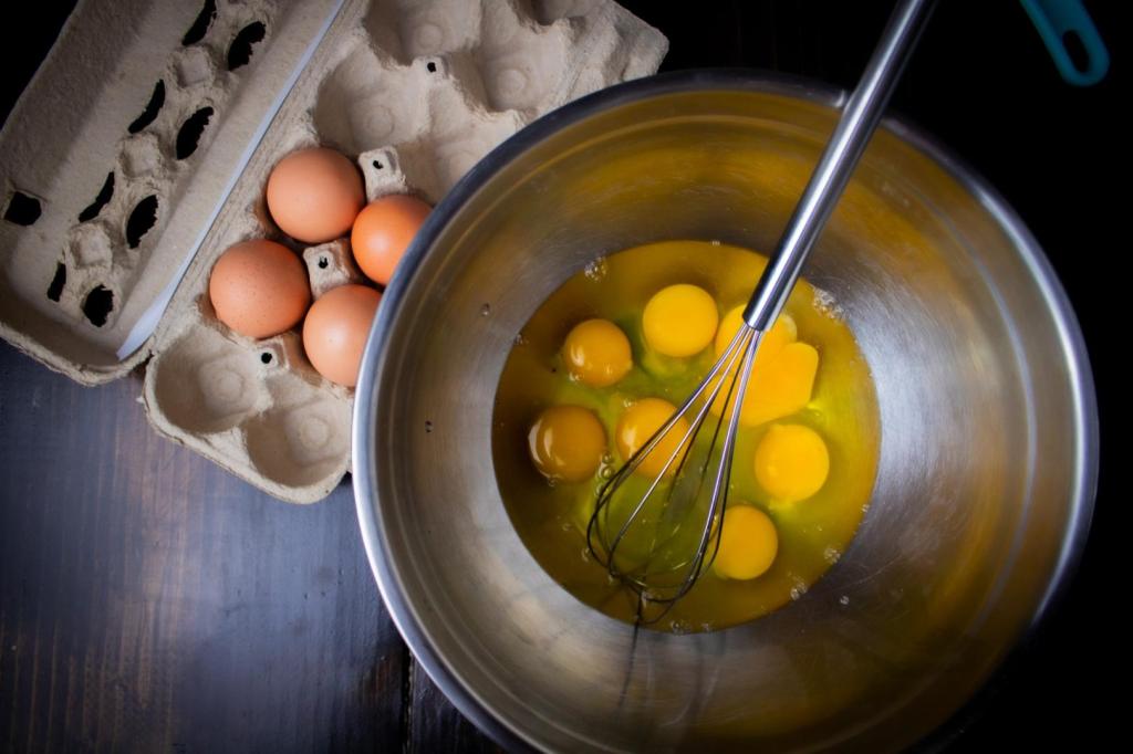 Eggs are whisked in a mixing bowl.