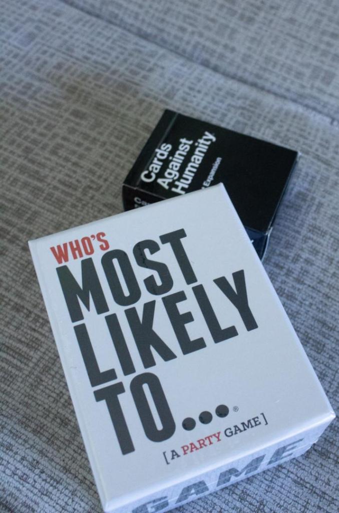 A couple of card games are laid out for playing on a game night.