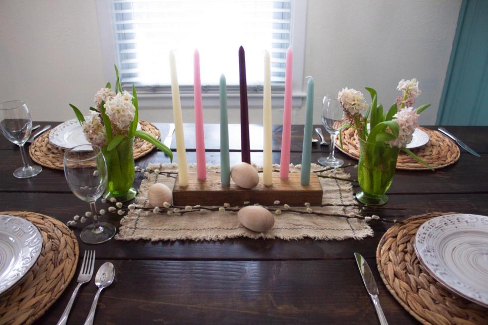 An Easter tablescape is set up on a long dining room table.