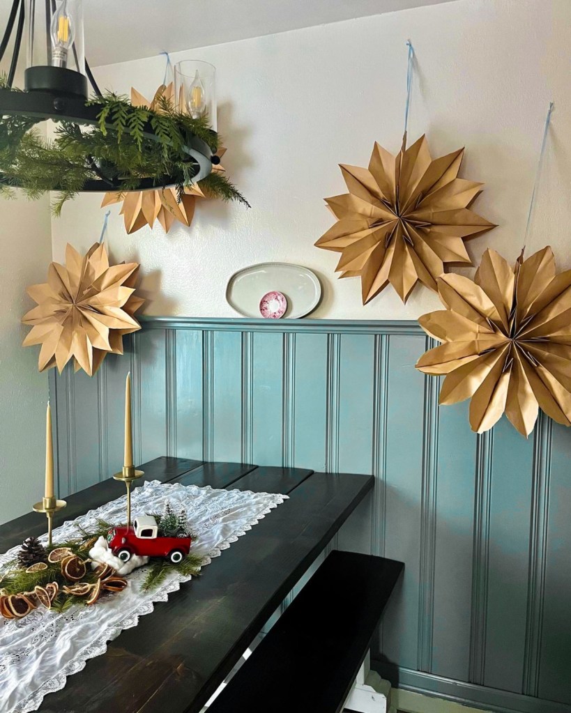 Paper snowflakes are hung in a kitchen during Christmas after following a paper snowflake tutorial.