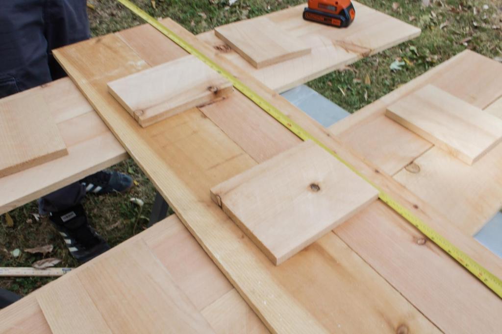 Smaller sides are lined up and are having fasteners added to them.