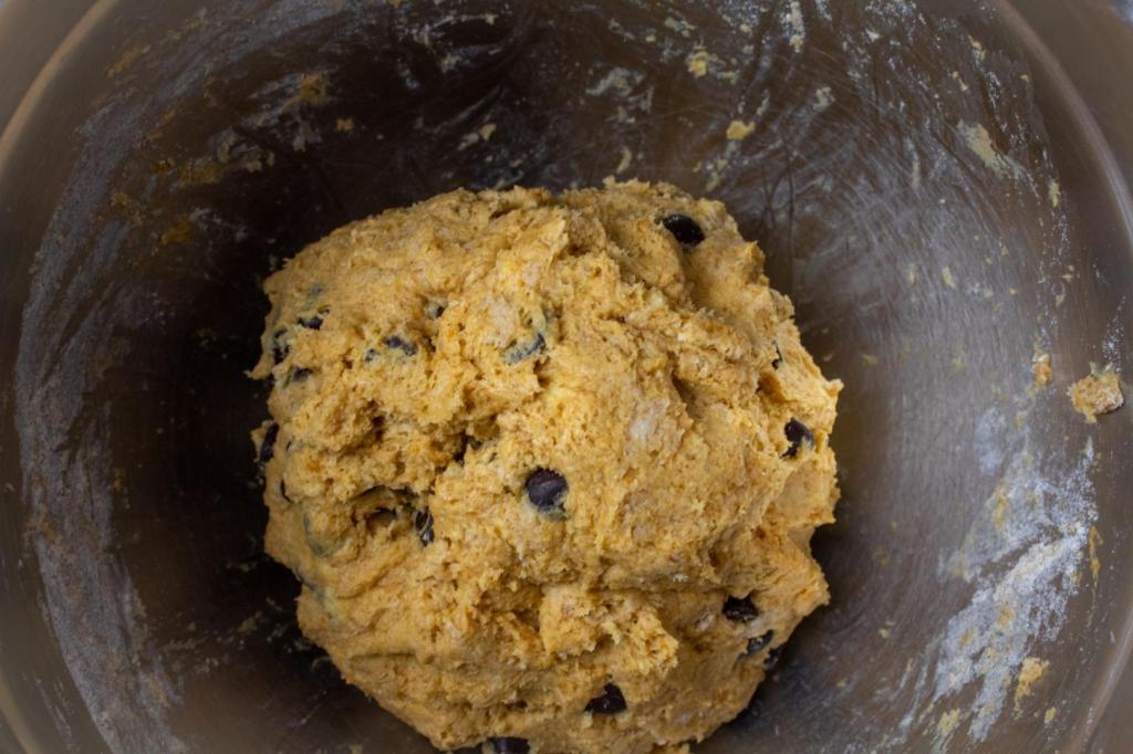 Pumpkin chocolate chip scones are mixed up in a bowl before baking.