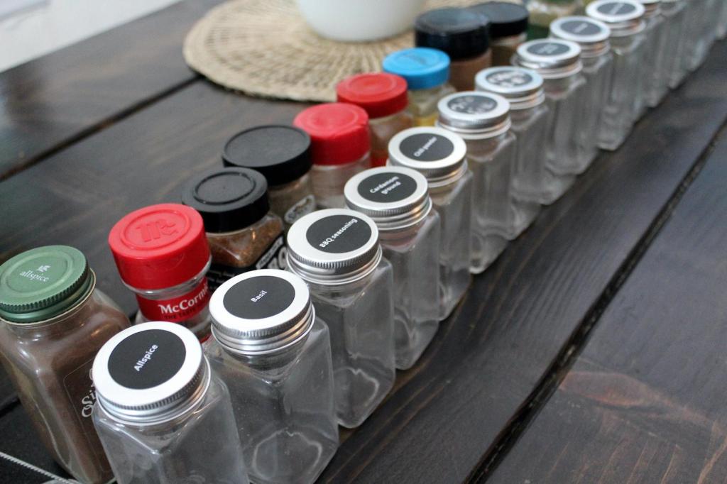 Empty bottle are about to be filled with spices.