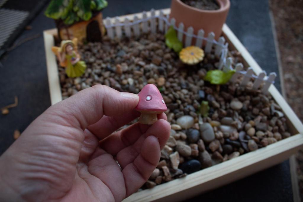 A mushroom is added into a little garden.