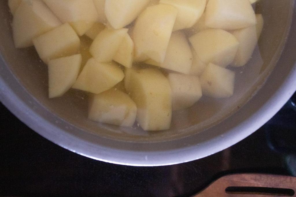 Potatoes have been cubed and added to a pot of water.