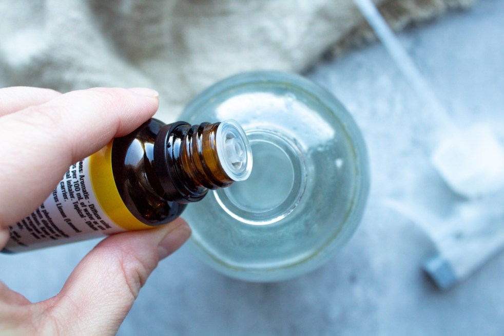 Homemade window cleaner with vinegar has essential oils added to it.