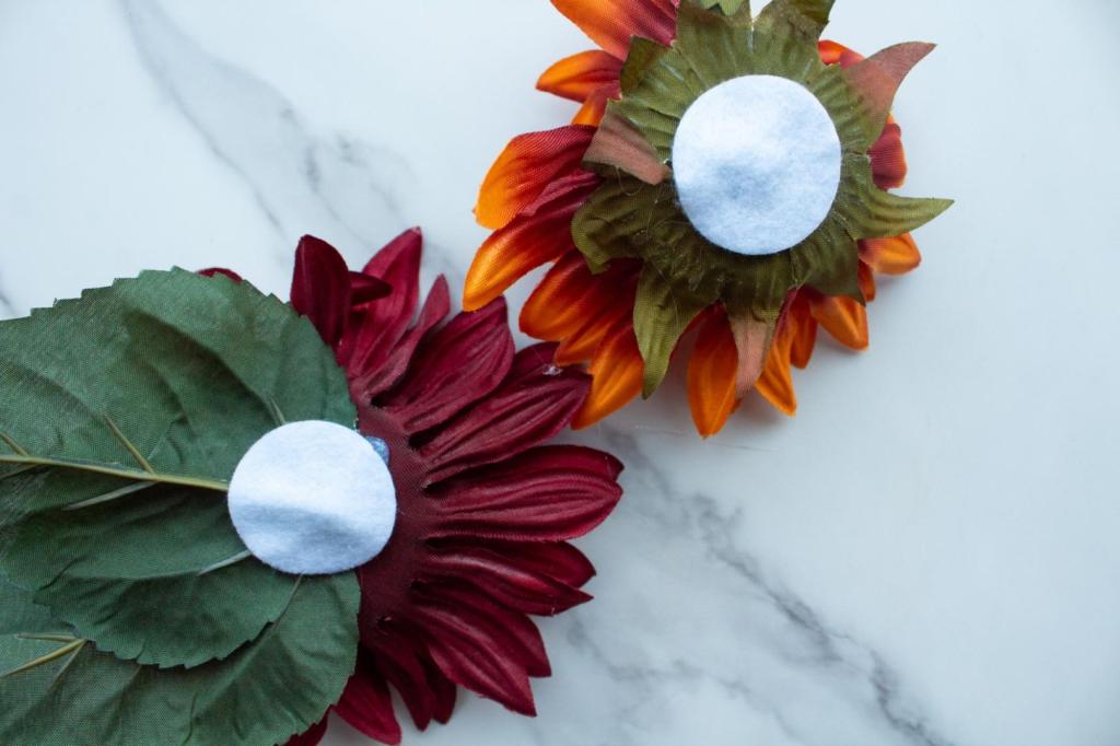 Felt circles are glued to the backs of flowers.