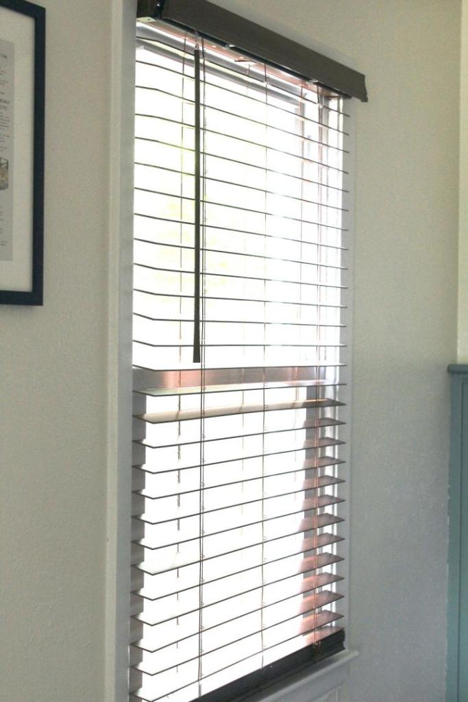 A before image of dark window blinds.