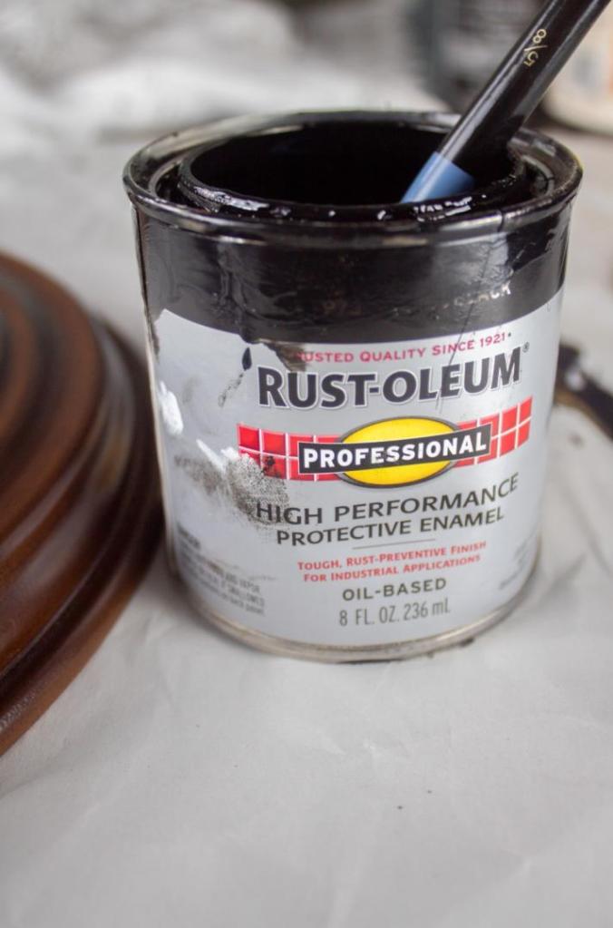 An oil-based paint has a brush dipped into it.