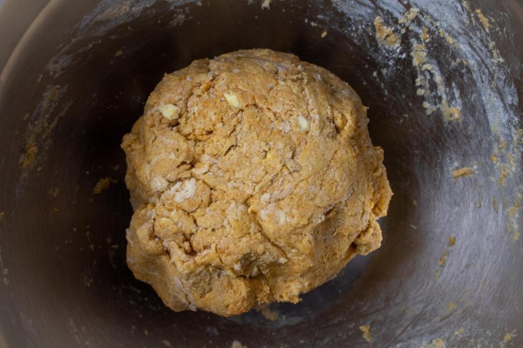A scone mixture is balled up in a bowl.