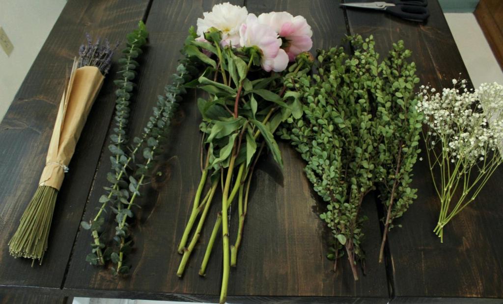 Flowers are laid out on a dining table.