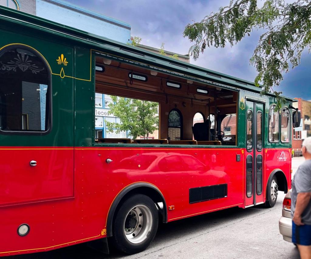 A trolley is showing tourists sights of the town of Hannibal MO.