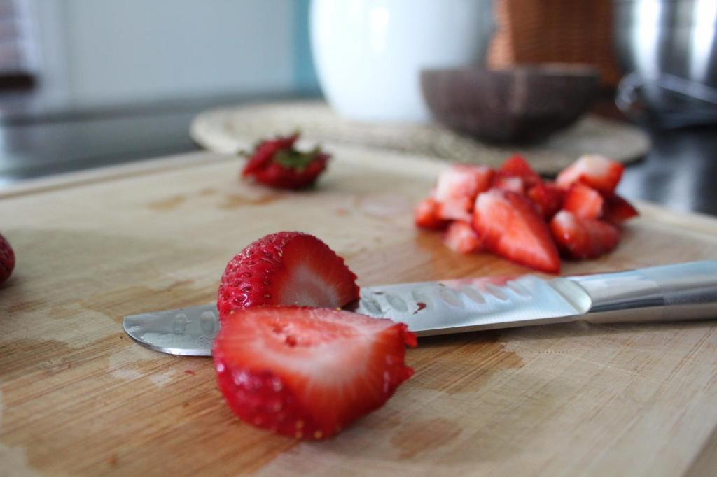 Strawberries are sliced for an easy muffin recipe.