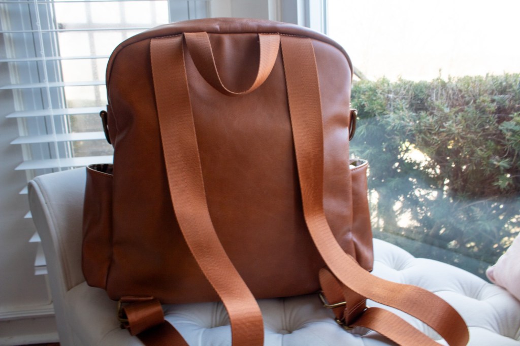 The back f the milkmaid goods diaper bag is shown with straps.