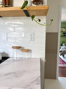 A DIY subway tile backsplash shines in its glossy, finished state.