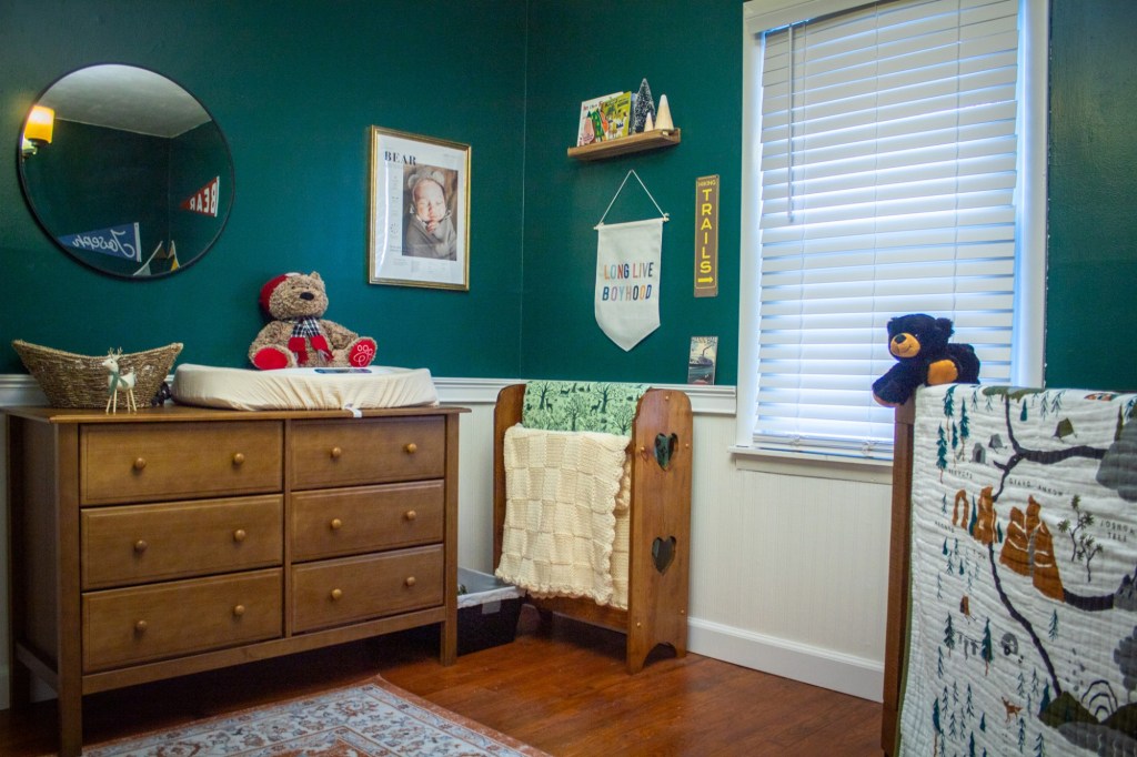 A national park theme nursery is decked out in natural woods, earthy colors, and pieces of rustic decor.