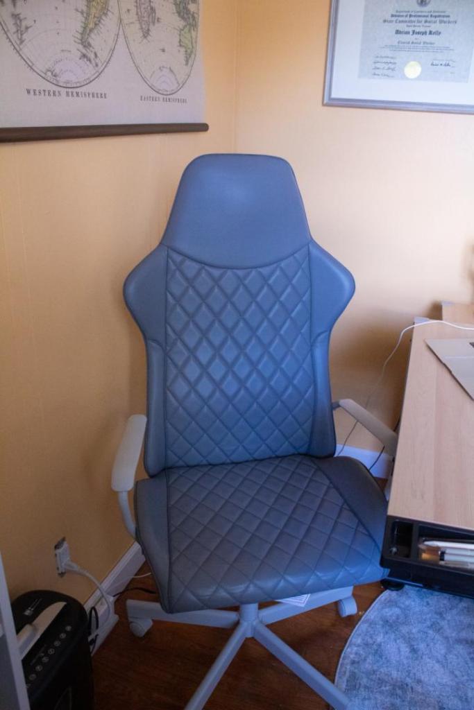 A gaming chair is being used as an office desk.