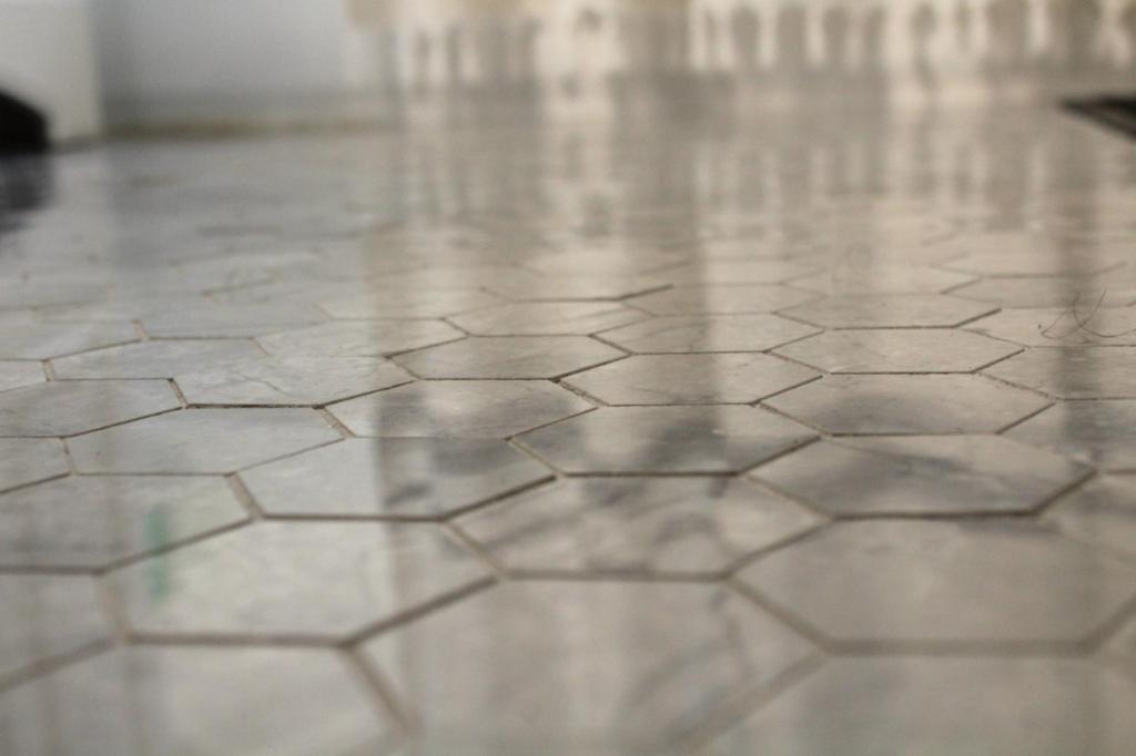 Bathroom floors shine with their hexagonal porcelain tiles.