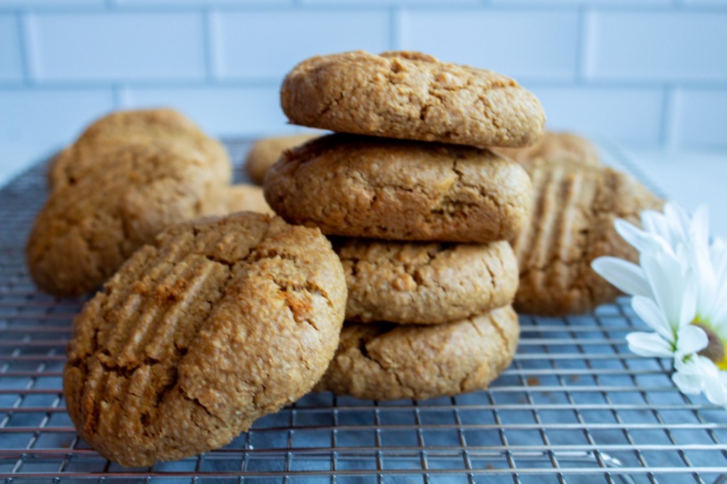 Stacked peanut butter cookies are shown off on a cooling rack.