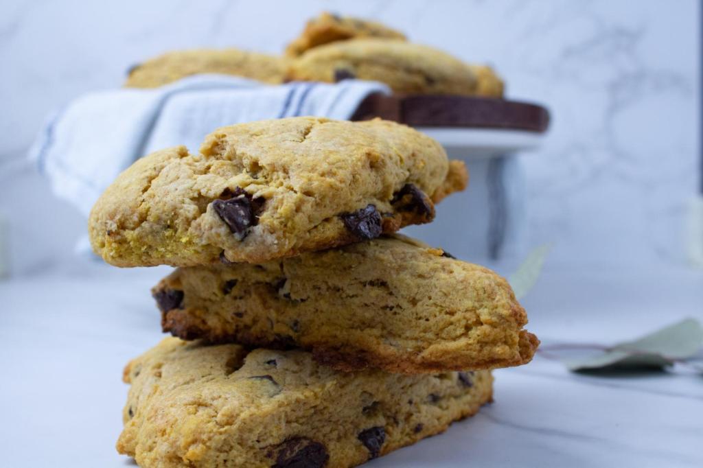Scones are stacked in front of a cake stand.